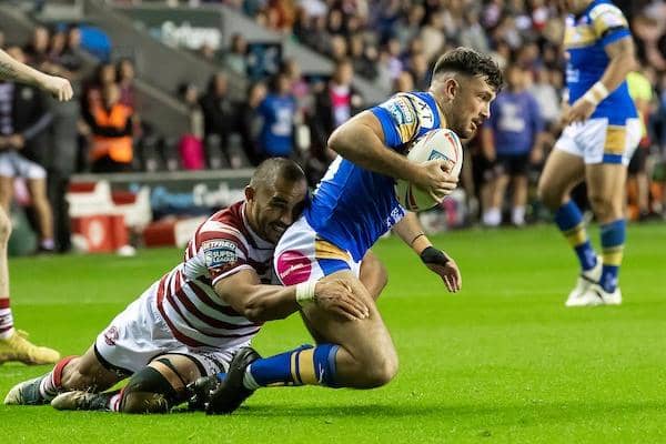 Liam Tindall is tackled by Wigan's Thomas Leuluai during Rhinos' semi-final win last week. Picture by Allan McKenzie/SWpix.com.