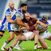 James Bentley, right, tackles Huddersfield Giants' Jake Bibby, along with Leeds Rhinos teammates Matt Frawley and Rhyse Martin. Picture by Allan McKenzie/SWpix.com.
