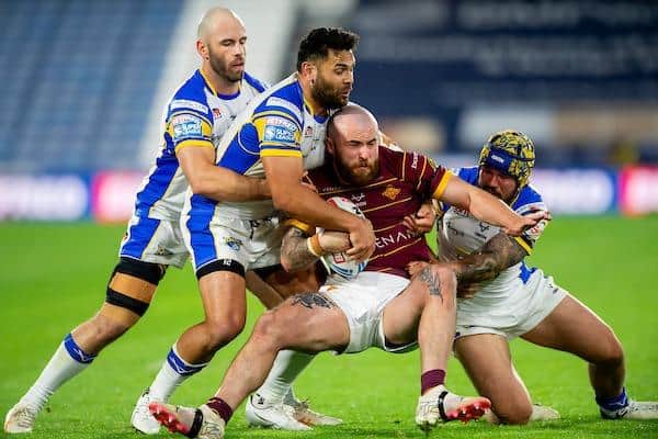 James Bentley, right, tackles Huddersfield Giants' Jake Bibby, along with Leeds Rhinos teammates Matt Frawley and Rhyse Martin. Picture by Allan McKenzie/SWpix.com.