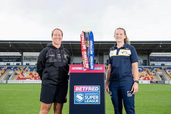 Rhinos coach Lois Forsell with York rival Lindsay Anfield and the Betfred Women's Super League trophy at LNER Community Stadium which will host Sunday's final. Picture by Allan McKenzie/SWpix.com.
