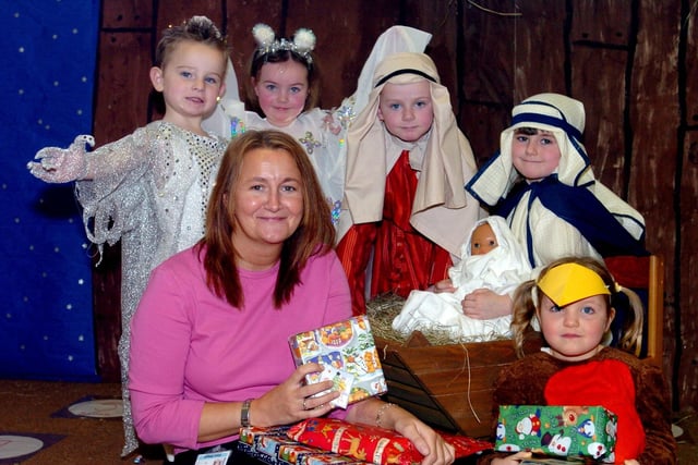 Pupils from Manston St James's Primary held their Christmas nativity play in December 2003 and were collecting Christmas presents for St James's Hospital A&E department.  Pictured receiving the presents are Diane Steeple from St James's and, from left, Callum Levine, Bethany Coyle, Robert Gillard, Holly Ellis and Samantha Lewis.