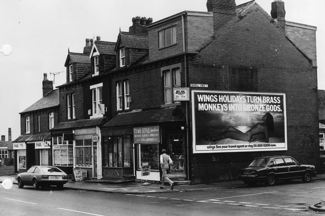 Shops on Harehills Lane in March 1982. These include Tyme Style Jewellers, Anglia Building Society and Paul, hair stylist. The junction with Nowell View is on the right.
