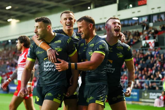 Chris Hankinson, second from right, celebrates with Jake Connor, Ash Handley and Harry Newman after scoring Leeds Rhinos' opening try in the 34-6 win at St Helens. Picture by Paul Currie/SWpix.com.
