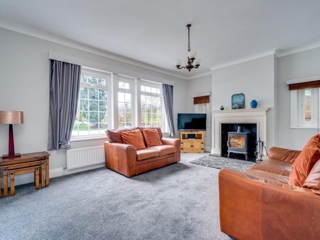 The spacious lounge has a feature fireplace, and large windows that admit plenty of natural light.