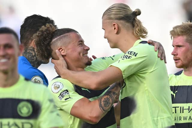 Manchester City's Norwegian striker Erling Haaland celebrates with Manchester City's English midfielder Kalvin Phillips (L) (Photo by JUSTIN TALLIS/AFP via Getty Images)