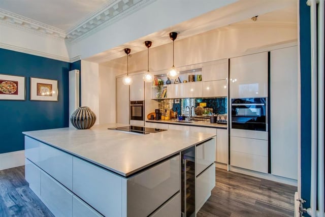 The bespoke, contemporary style kitchen has high gloss units.