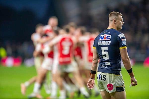 Dejection for Rhinos' Ash Handley as Hull KR celebrate their golden-point win. Picture by Allan McKenzie/SWpix.com.