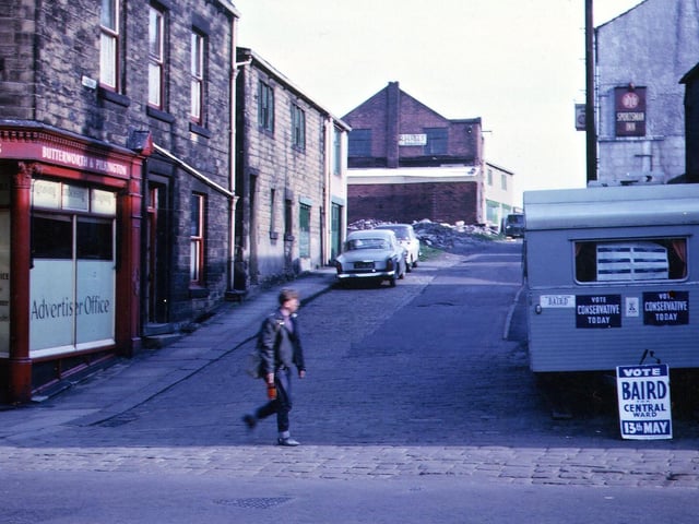 View of the Conservative Committee Rooms on Hunger Hill, seen from Fountain Street, on election day. A trailer outside has notices saying "Vote Conservative Today" and "Vote Baird, Central Ward, 13th May". Behind this is the Sportsman Inn. On the left are the premises of Butterworth and Pilkington, printers.