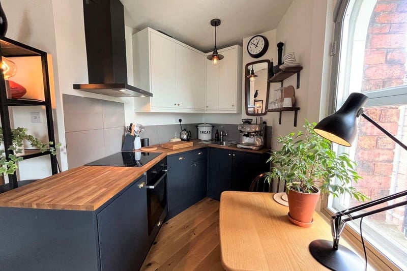 The kitchen area has a range of fitted modern units and contrasting wooden worksurface. Integrated appliances include; a dishwasher, fridge, electric oven, four ring hob with extractor fan over.
