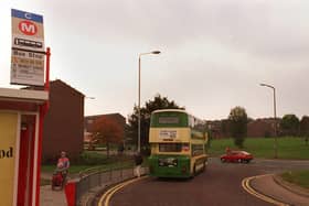 A bus standing at Bramley Shopping Centre bus terminal with the Rossefield estate in the background in October 1997.
