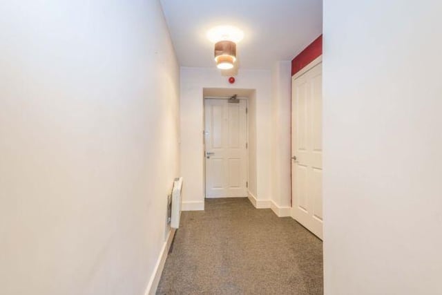 The flat has a communal entrance with an entry intercom system. On entry to the apartment, there is a hallway with a storage cupboard.