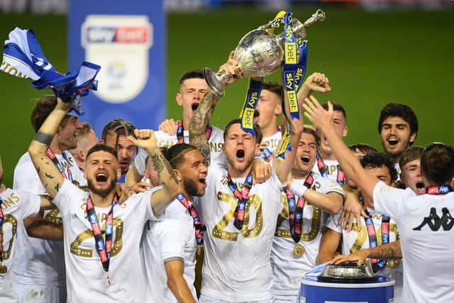 LEEDS, ENGLAND - JULY 22: Liam Cooper of Leeds United lifts the trophy in celebration with team mates after the Sky Bet Championship match between Leeds United and Charlton Athletic at Elland Road on July 22, 2020 in Leeds, England. Football Stadiums around Europe remain empty due to the Coronavirus Pandemic as Government social distancing laws prohibit fans inside venues resulting in all fixtures being played behind closed doors. (Photo by Michael Regan/Getty Images)