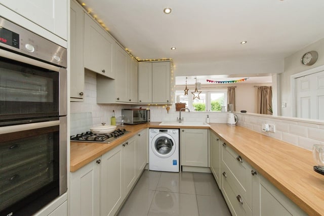 The kitchen includes an electric double oven with a gas hob and extractor over and opens out to the dining room. Photo: Zoopla