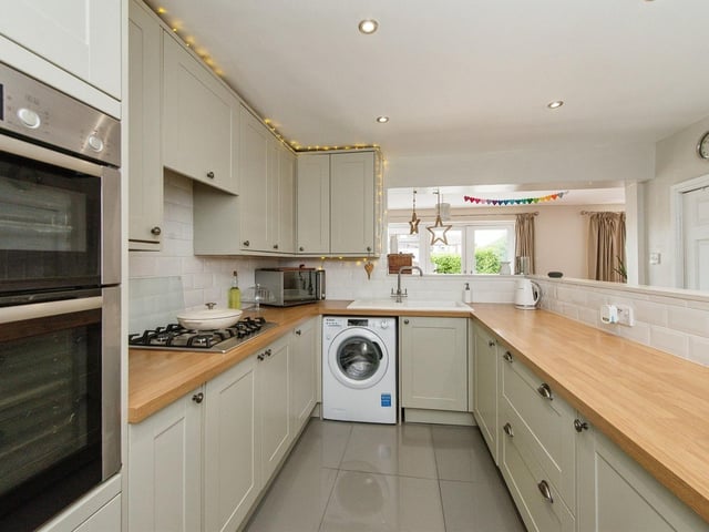 The kitchen includes an electric double oven with a gas hob and extractor over and opens out to the dining room. Photo: Zoopla
