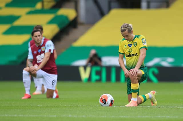 Todd Cantwell of Norwich City takes a knee in support of the Black Lives Matter movement prior to the Premier League match between Norwich City and Burnley FC at Carrow Road on July 18, 2020 in Norwich, England.