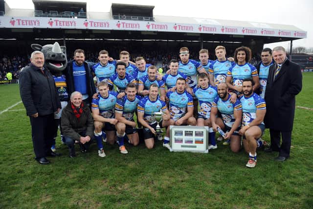 Wakefield legend Neil Fox, far left of picture, with Rhinos players and the Festive Challenge trophy after the 2014 Boxing Day game. Picture by Steve Riding.