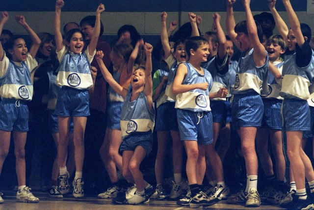 Children from Temple Newsam Halton Primary School cheer as their team-mates win one of the races in the Sportshall Athletic Challenge held at Richmond Hill Sports Centre in December 1997.