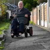 Retired bus driver Leslie Fowkes, 68, says he has been complaining about a dip in Bawn Approach for months amid fears he could fall from his wheelchair. Photo: Jonathan Gawthorpe