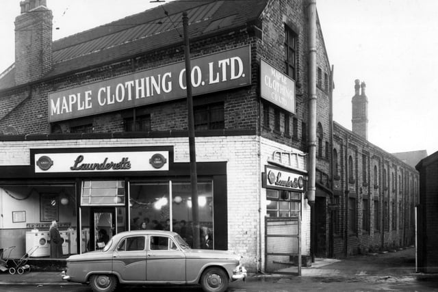 A car parked outside self service laundrette Bendix on Dewsbury Road in December 1958. Above and behind the laundrette is the Maple Clothing Co Ltd, blouse factory. On the right is Admiral Street.
