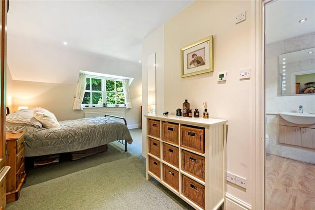 The master bedroom is 'L' shaped and has fitted wardrobes and an en-suite bathroom.