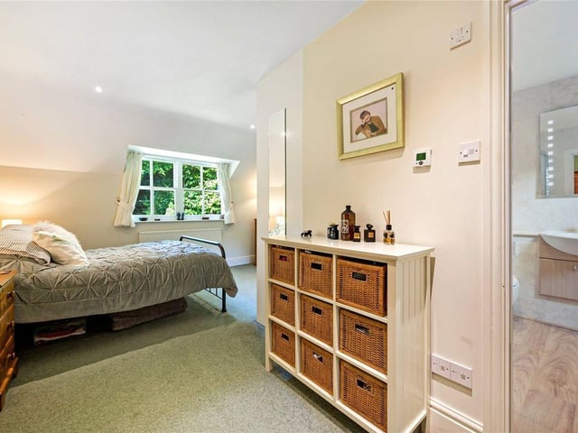 The master bedroom is 'L' shaped and has fitted wardrobes and an en-suite bathroom.