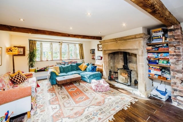 Wooden beams, stone inglenook fireplaces and parquet flooring are reminders of the age of the original building, with a multi-fuel burner and under floor heating adding more modern style warmth in this lounge.