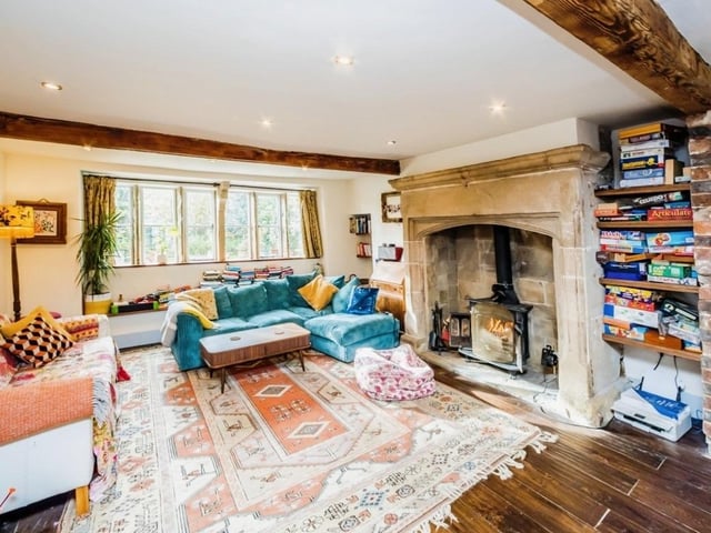 Wooden beams, stone inglenook fireplaces and parquet flooring are reminders of the age of the original building, with a multi-fuel burner and under floor heating adding more modern style warmth in this lounge.