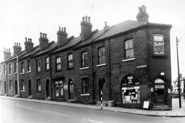 Cemetery Road is on the left with a shop at the corner with Elland Road. A chemists shop is in view, the business of M. Clarkson. The main entrance for the shop was located round the corner (on the right) at 113 Elland Road. Two houses on Rothsay Place, were also incorporated to become one building. The shop at the corner a grocers is 111 Elland Road, run by Harold Douglas Firth, Elland Road can be seen on the right, the Waggon and Horses public house is in view.