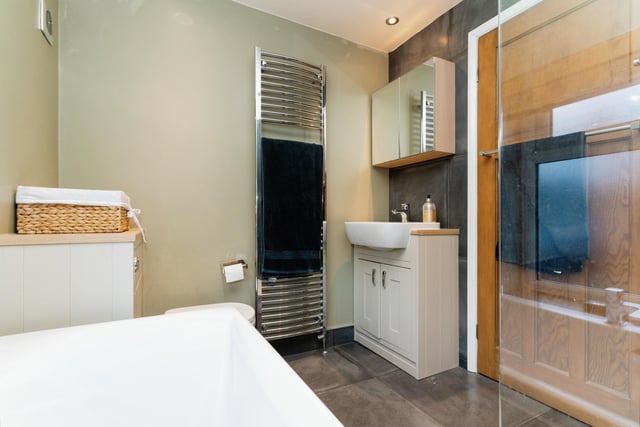 The modern house bathroom has both a shower cubicle and a bath.