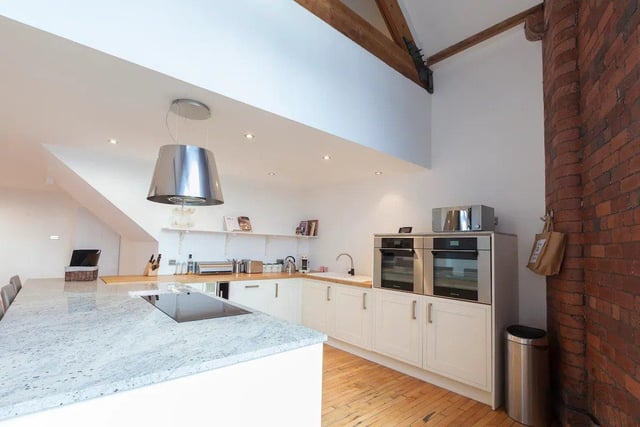 A gorgeous kitchen is fully fitted with two ovens, an induction hob, a wine fridge and a Nespresso coffee machine.