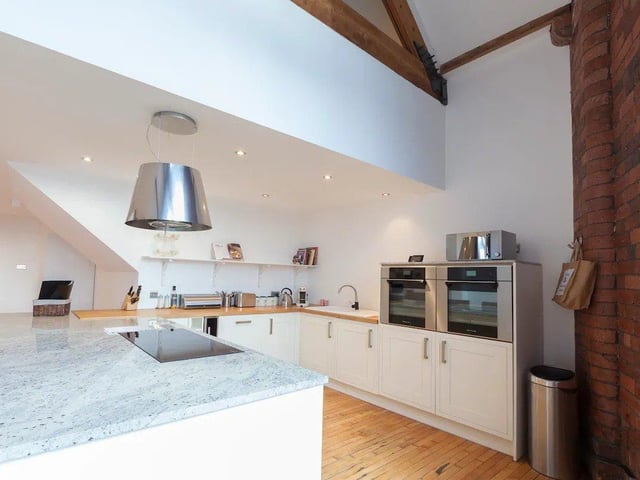 A gorgeous kitchen is fully fitted with two ovens, an induction hob, a wine fridge and a Nespresso coffee machine.