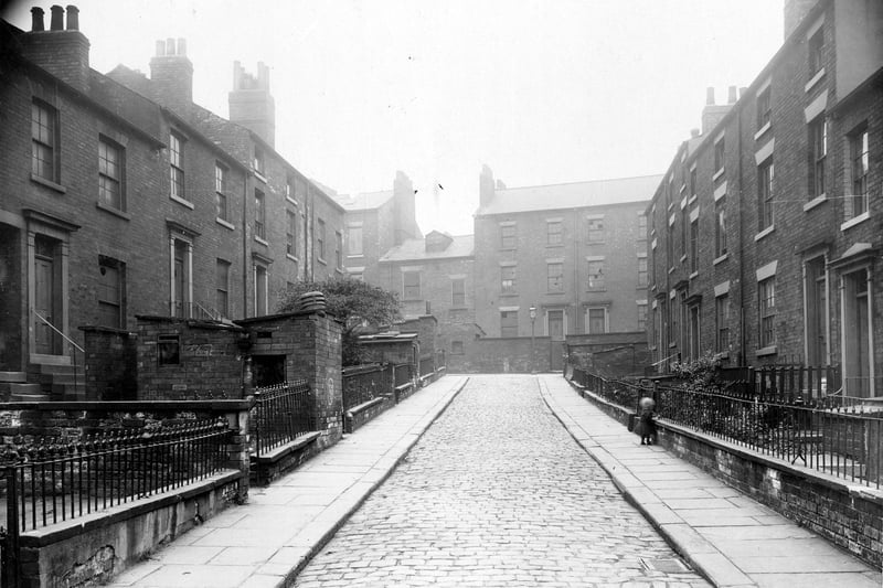 This view looks north towards South Carnaby Street in August 1913. Houses of varying size, with yards or gardens. Some on the left have brick out-buildings, could be outside toilets or wash-houses, that is a facility for boiling water for laundry. Chimneys can be seen, the water would be boiled in a small coal-fired boiler.