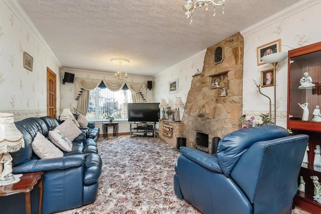 The spacious living room has an exposed stone fireplace, making it a real focal point in the room, glazed doors leading through to the dining room and a uPVC double glazed window to the front.