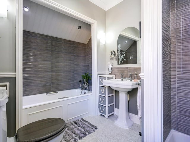 The modern house bathroom is completed with a four piece suite.