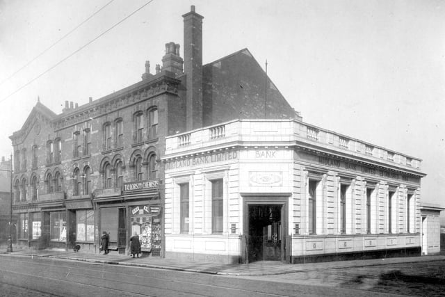Hunslet Road between Stafford Street and Pitfield Street in March 1929. Midland Bank on the corner with Stafford Street next to Taylors Chemists, Arthur Fielding. The other premises appear to be closed. 2 people can be seen on the street.