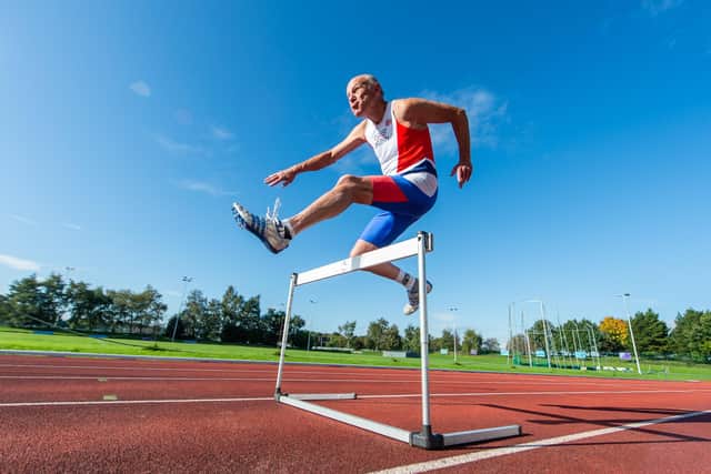 Tony Bowman taking on hurdles back when he was 84. Photo: Alex Cousins/SWNS