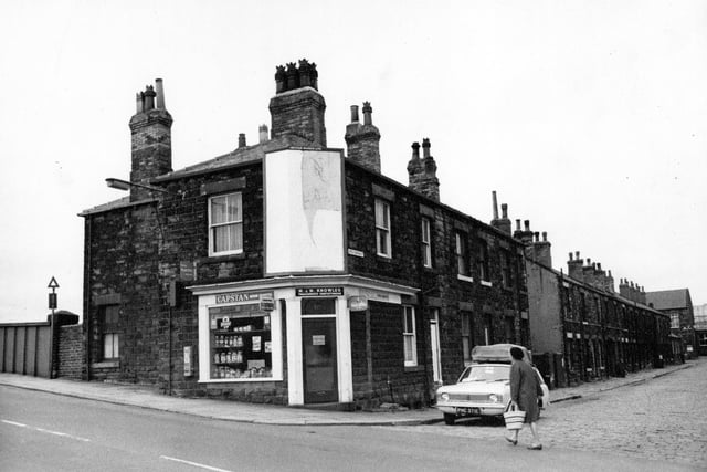 Fountain Street at the junction with Little Fountain Street in August 1968. The shop is a tobacconist and confectioners owned by M. and M. Knowles. The bridge over the railway lines can be seen to the left. A woman is crossing Little Fountain Street in front of a parked car.