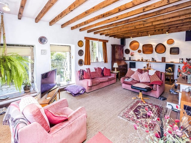 Natural light pours in to this room through its sizeable picture windows.