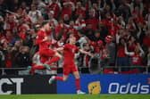 Denmark's forward Andreas Skov Olsen (L) celebrates scoring the 2-0 goal with his team-mate Denmark's defender Rasmus Kristensen during the UEFA Nations League football match between Denmark and France in Copenhagen on September 25, 2022. (Photo by FRANCK FIFE / AFP) (Photo by FRANCK FIFE/AFP via Getty Images)