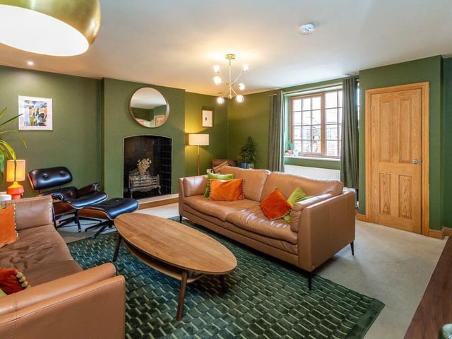A stunning open fireplace is the central feature in the lounge, providing a focal point alongside the window overlooking the rear garden and patio area.
