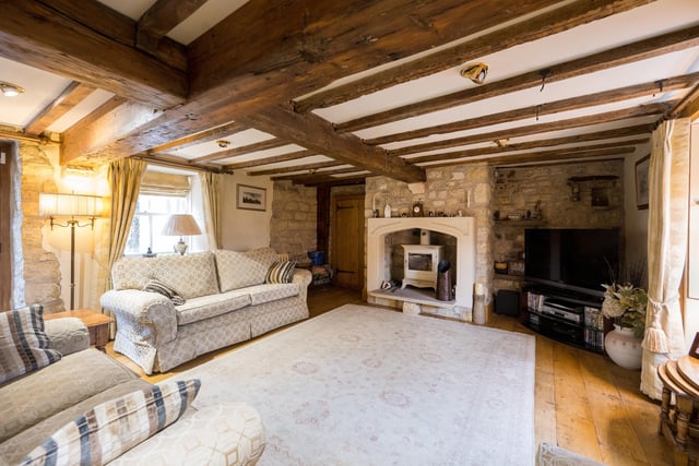 The principal reception room is a delightful well proportioned sitting room with a wealth of exposed beams, feature stone walls, fireplace with multifuel stove and oak flooring.