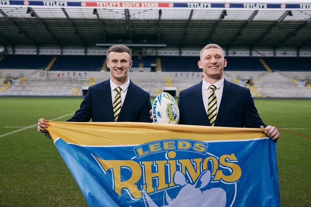 Leeds Rhinos' Ash Handley and Mikolaj Oledzki celebrate Skopes becoming the club's official tailoring partners for 2025. Picture by Rob Smalley.