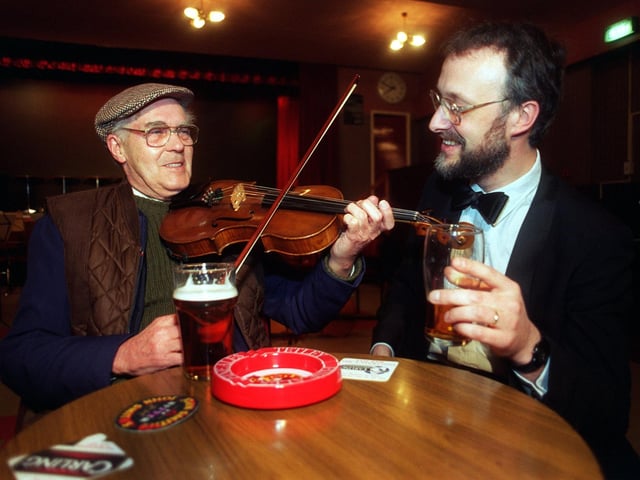 Retired engineer, Joseph Wright, receives a quick lesson in Viola playing from New Yorkshire Symphony Orchestra member, Christopher Gibbs, before a concert held at the Swillington Miners Welfare Club in February 1997.