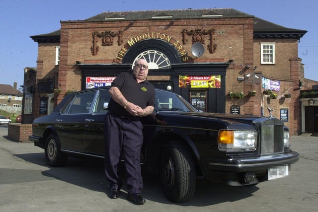 Millionaire Jeff Cains pictured with his Rolls Royce outside the Middleton Arms in March 2003 where he worked as a doorman.