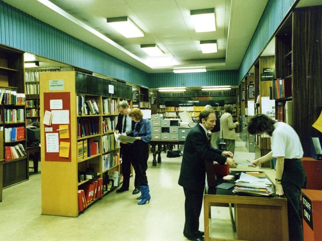 Library of Commerce, Science and Technology when situated on the ground floor of Leeds Central Library. Known popularly as the Commercial and Technical Library, it housed all the information for business as well as the library's stock of books and journals on science and technology. A man and woman can be seen consulting company information on shelves to the left, while on the right a man is making a request at the counter.