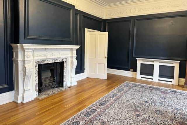 Apartment A on the ground floor of The Hollies features a 23ft living room with high ceilings, ornate cornicing and plasterwork and a grand fireplace.