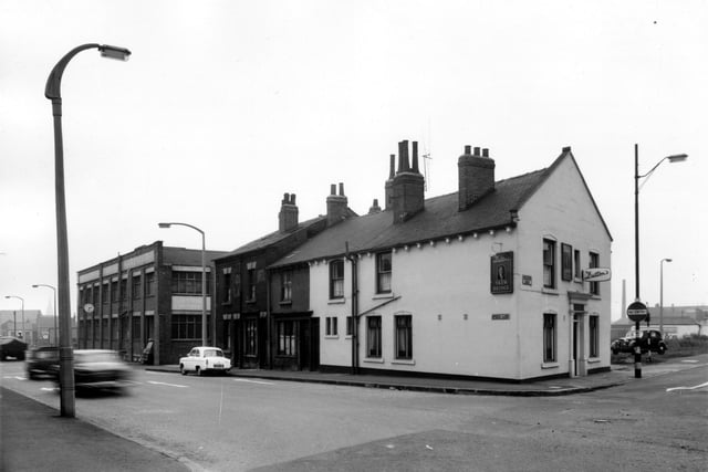 This view looks from Gelderd Road along Spence Lane in the direction of Whitehall Road. On the left is the premises of J. and H. Smith Ltd, builders hardware and machinery merchants. This is Corner House on Whitehall Road. Moving right, three residential properties on Spence Lane then the Skew Bridge public house on Gelderd Road. Pictured in March 1965.