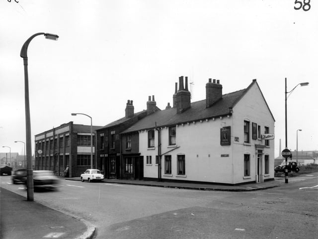 This view looks from Gelderd Road along Spence Lane in the direction of Whitehall Road. On the left is the premises of J. and H. Smith Ltd, builders hardware and machinery merchants. This is Corner House on Whitehall Road. Moving right, three residential properties on Spence Lane then the Skew Bridge public house on Gelderd Road. Pictured in March 1965.