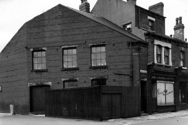 To the left is the corner of Anchor Road and Joseph Street. A sign indicates that the building facing the front was used by Winifred Hunt Bespoke Tailoring. They had an office and fitting rooms at 88 Joseph Street, which is just visible on the left edge of this view. Between the two at 90 Joseph street is a grocers and confectioners shop, business of J. Bisbey. Pictured in June 1964.