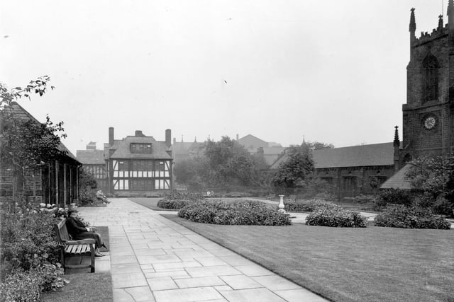This Garden of Rest was created and maintained by trustees of Wade's Charity, which is a memorial to Thomas Wade. In 1530 his will stipulated that money should be used to benefit the people of Leeds. several public spaces were created. This three-quarter acre site was opened in 1933. St. Johns Church is on the right.  The mock-Tudor building is St. Johns House opened in 1930 which fronted onto Merrion Street.